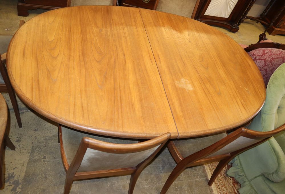 A G plan teak extending dining table and six chairs (two with arms), table W.160cm, D.100cm, H.70cm